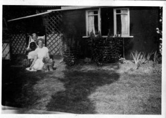 The Poplars residence showing my Mother and Grandmother at the side of house.